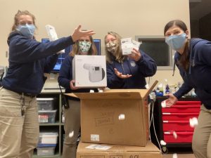 Employees at the Point Defiance Zoo hold up parts of the new dental x-ray machine they acquired.